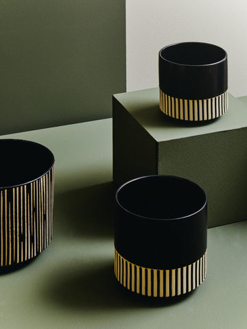 Black large ceramic planter with gold vertical stripes near the base perfect for stylish indoor plants