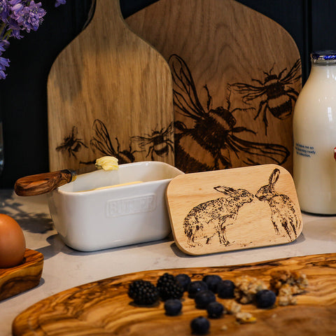 White ceramic kissing hare butter dish with wooden handle and engraved rabbit lid for serving butter