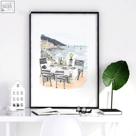 Black-framed kitchen painting sole di amalfi mediterranean coastal watercolor print of seaside dining with striped chairs and lantern
