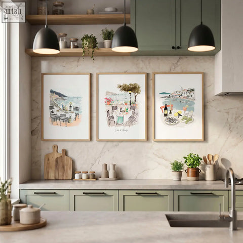 Three framed sole di amalfi kitchen paintings with mediterranean coastal watercolor prints above cabinets