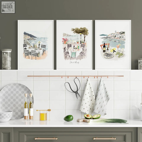 Three framed sole di amalfi kitchen paintings featuring mediterranean coastal watercolor prints above a counter