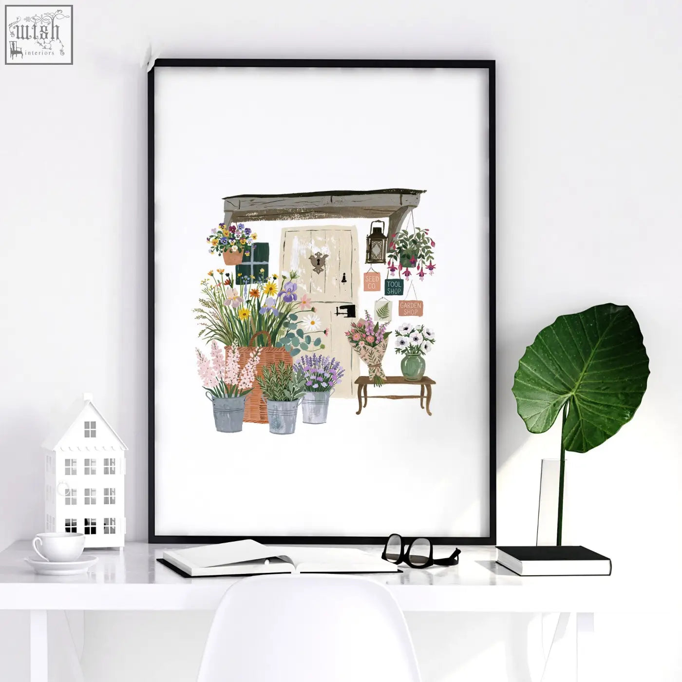 Black-framed kitchen print of a charming country cottage flower shop with vibrant pots and hanging blooms wall art set of 3