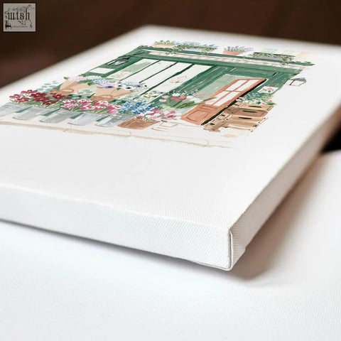 White canvas kitchen print featuring a country cottage flower shop with green shutters and vibrant potted blooms