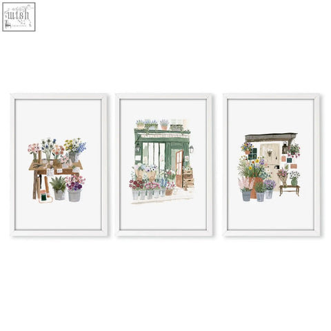 Set of three white-framed kitchen prints featuring charming country cottage flower shop watercolor art with vibrant blooms