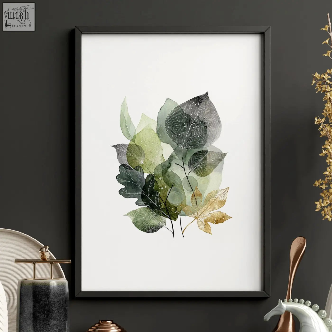 A framed kitchen wall artwork with layered green and gold tones leaves in watercolor and a sleek black frame