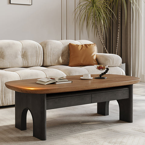 Modern knight coffee table with oval warm wood top and dark matte legs featuring arched supports and storage