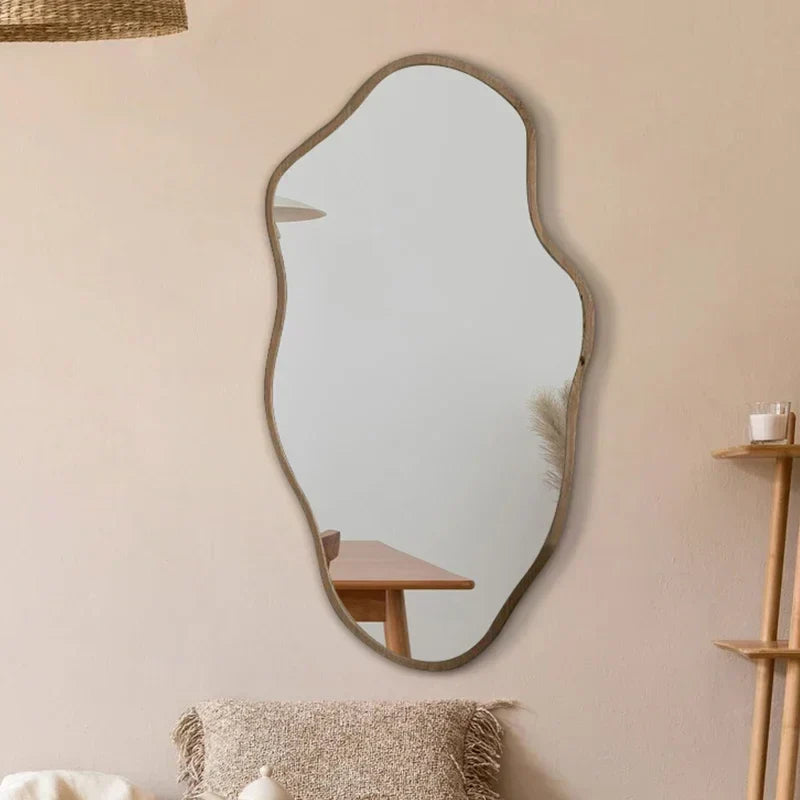A modern kohana mirror with an organic shape and matte gray frame perfect for stylish home decor