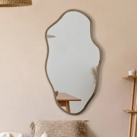 A modern kohana mirror with an organic shape and matte gray frame perfect for stylish home decor