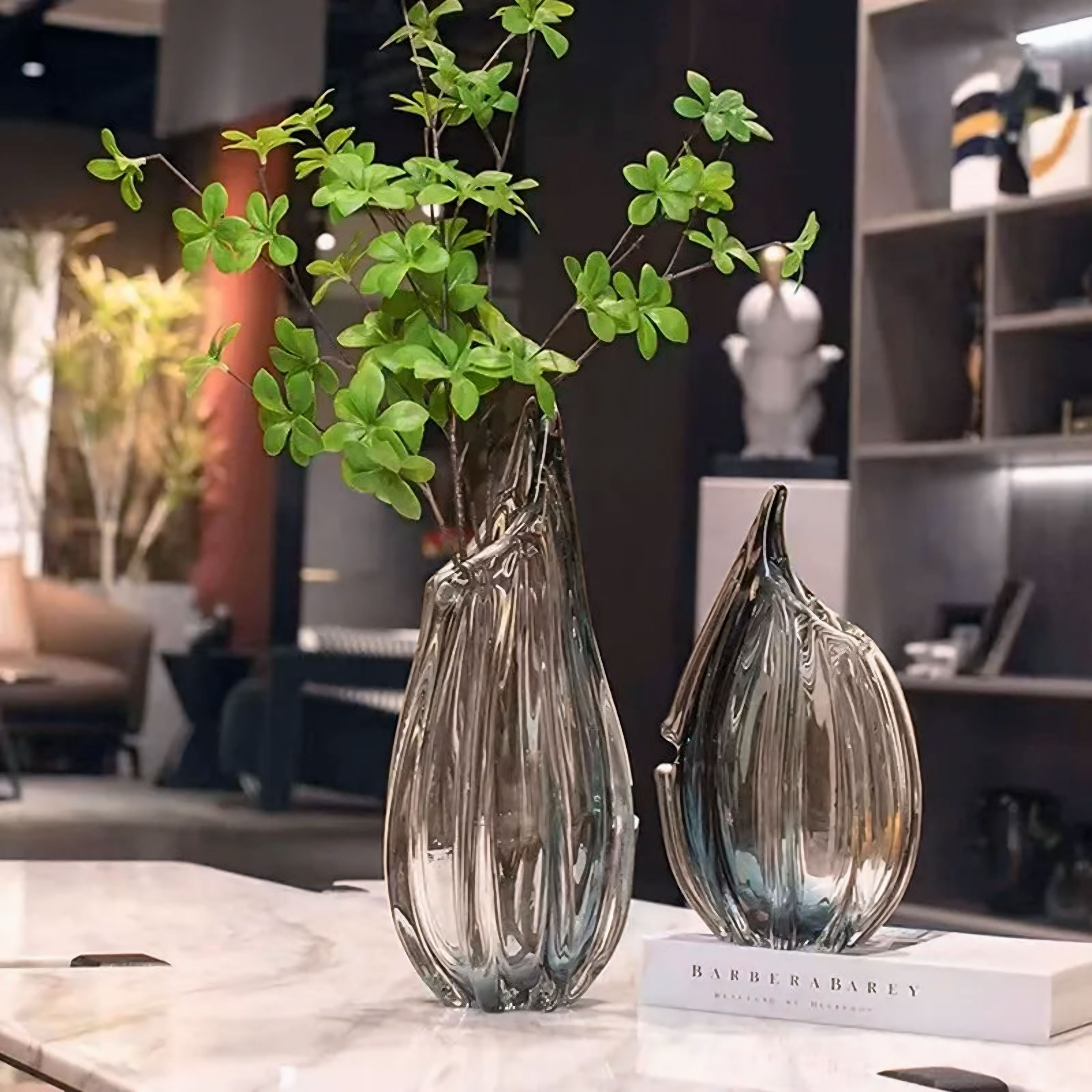 Two sleek transparent glass kokan vases with modern ribbed design and subtle metallic sheen perfect for decor