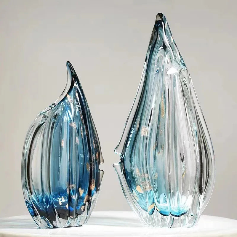 Two translucent blue glass kokan vases with vertical ridges and gold flecks shaped like seashells or leaves
