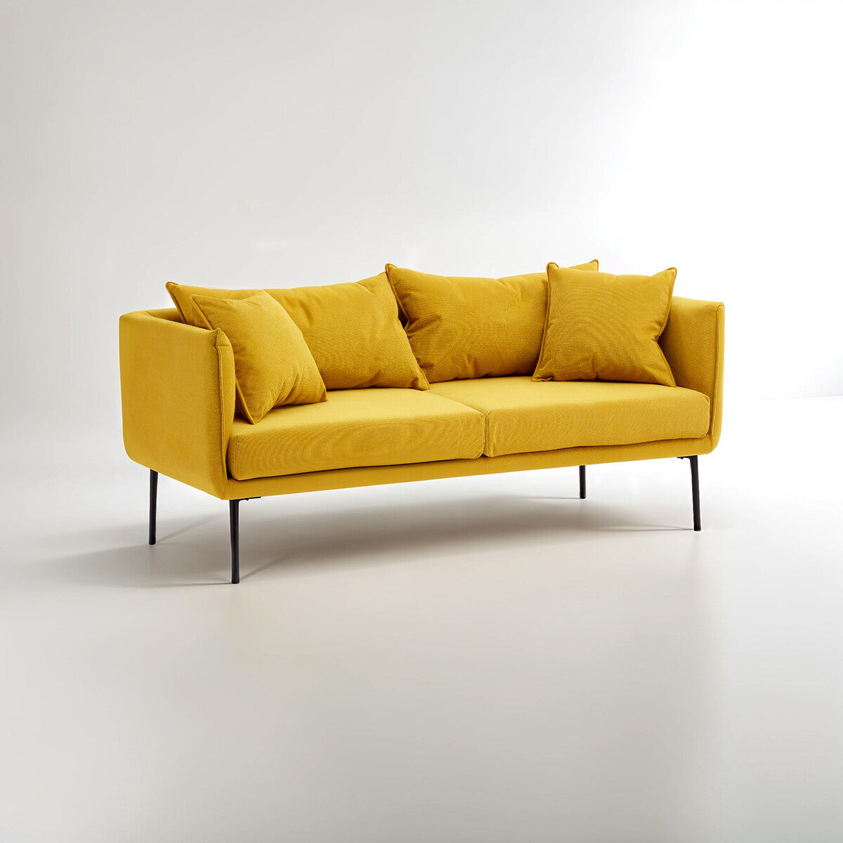 Kolding two seater velvet sofa in vibrant mustard yellow with sleek black metal legs and matching throw pillows