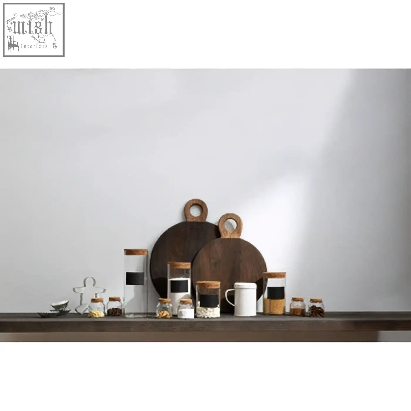 Set of minimalist ceramic mugs with wooden lids and handles beside a white and black striped mango wood chopping board