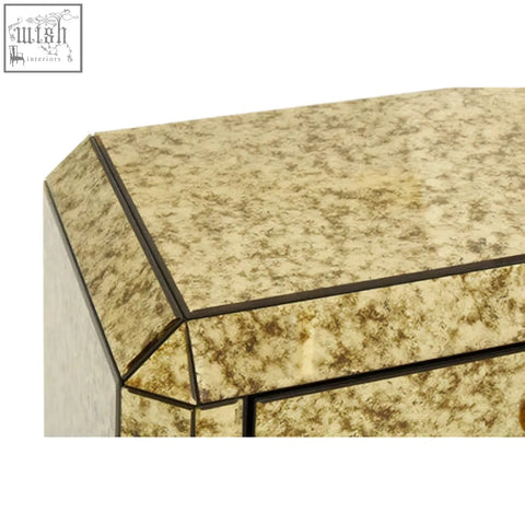 Gold-toned mirrored komo console table with geometric faceted design and dark metallic trim for stylish storage