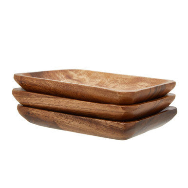 Stacked rectangular acacia wood serving dishes in warm brown with visible wood grain from kora acacia set of three
