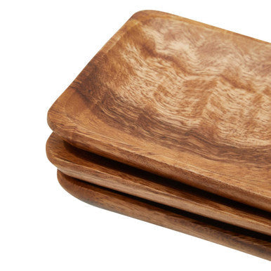 Stacked wooden coasters from kora acacia set of three serving dishes with warm natural finish and visible grain patterns