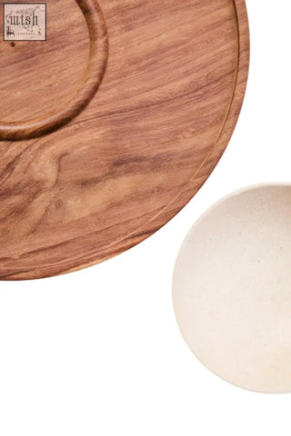 Light brown acacia wood serving board with circular cutout for cream marble chip and dip platter use