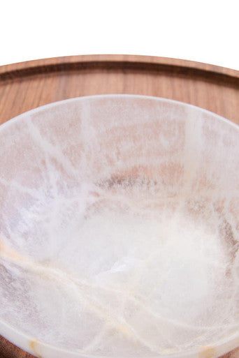 A translucent milky-white onyx chip and dip platter with subtle golden veining and acacia wood accents