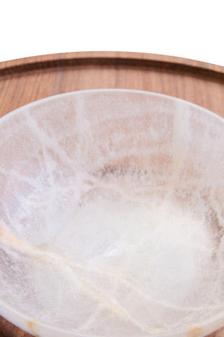 A translucent milky-white onyx chip and dip platter with subtle golden veining and acacia wood accents