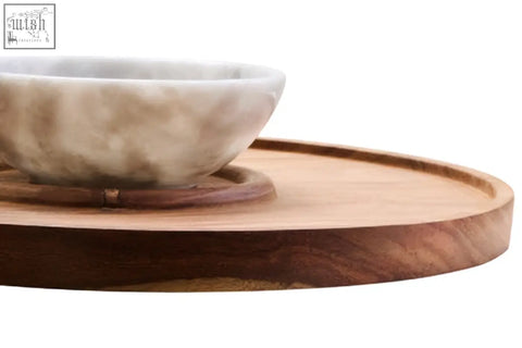 A beige white marble chip bowl with subtle veins on a circular kora acacia wood chip and dip platter