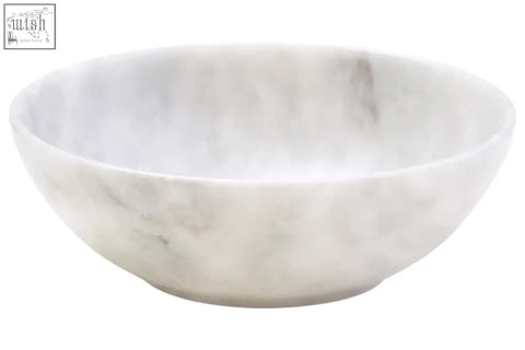 A smooth white marble chip bowl with subtle gray veining on the kora acacia wood chip and dip platter