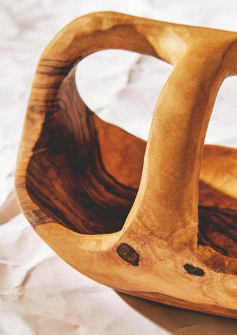 Handcrafted kora olive wood fruit bowl with smooth natural finish and dark grain patterns perfect for fruit display