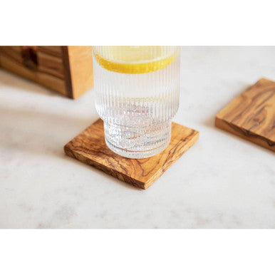 Square olive wood coaster with natural grain and warm brown tones from kora set of 4 wood square coasters