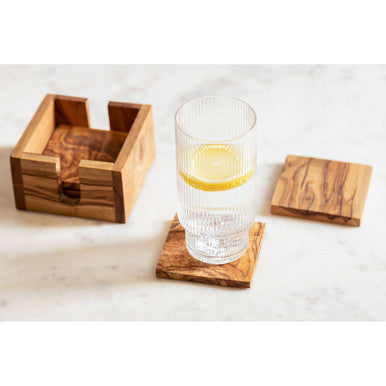 Kora set of 4 olive wood square coasters with natural grain and warm brown tones for stylish table use