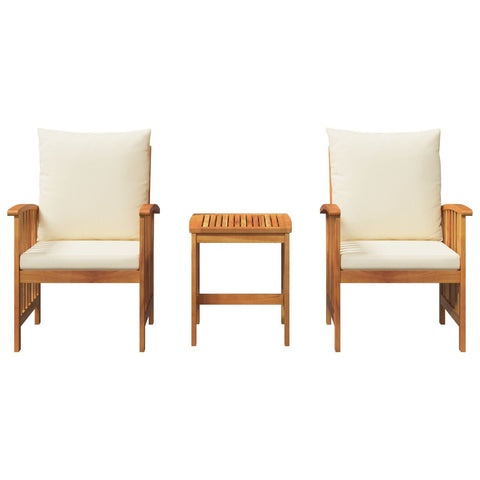 Set of two light brown solid acacia wood armchairs with cream cushions and matching slatted side table for outdoor dining set