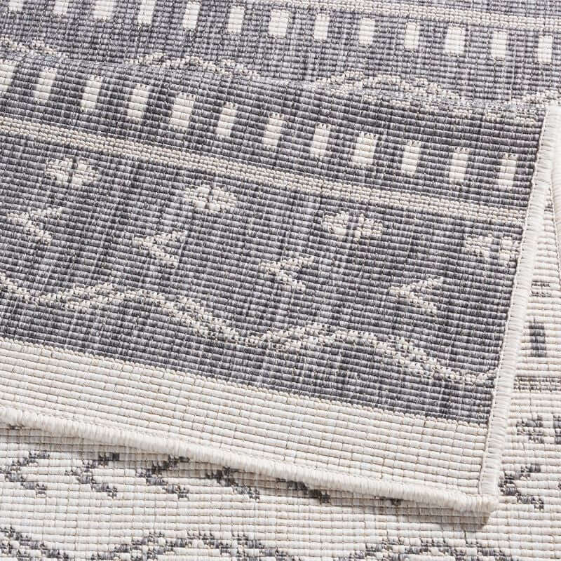Gray and white geometric-patterned kuba reversible indoor outdoor rug with durable textured woven material