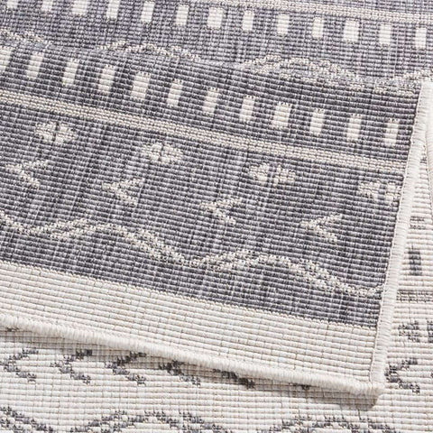 Gray and white geometric-patterned kuba reversible indoor outdoor rug with durable textured woven material