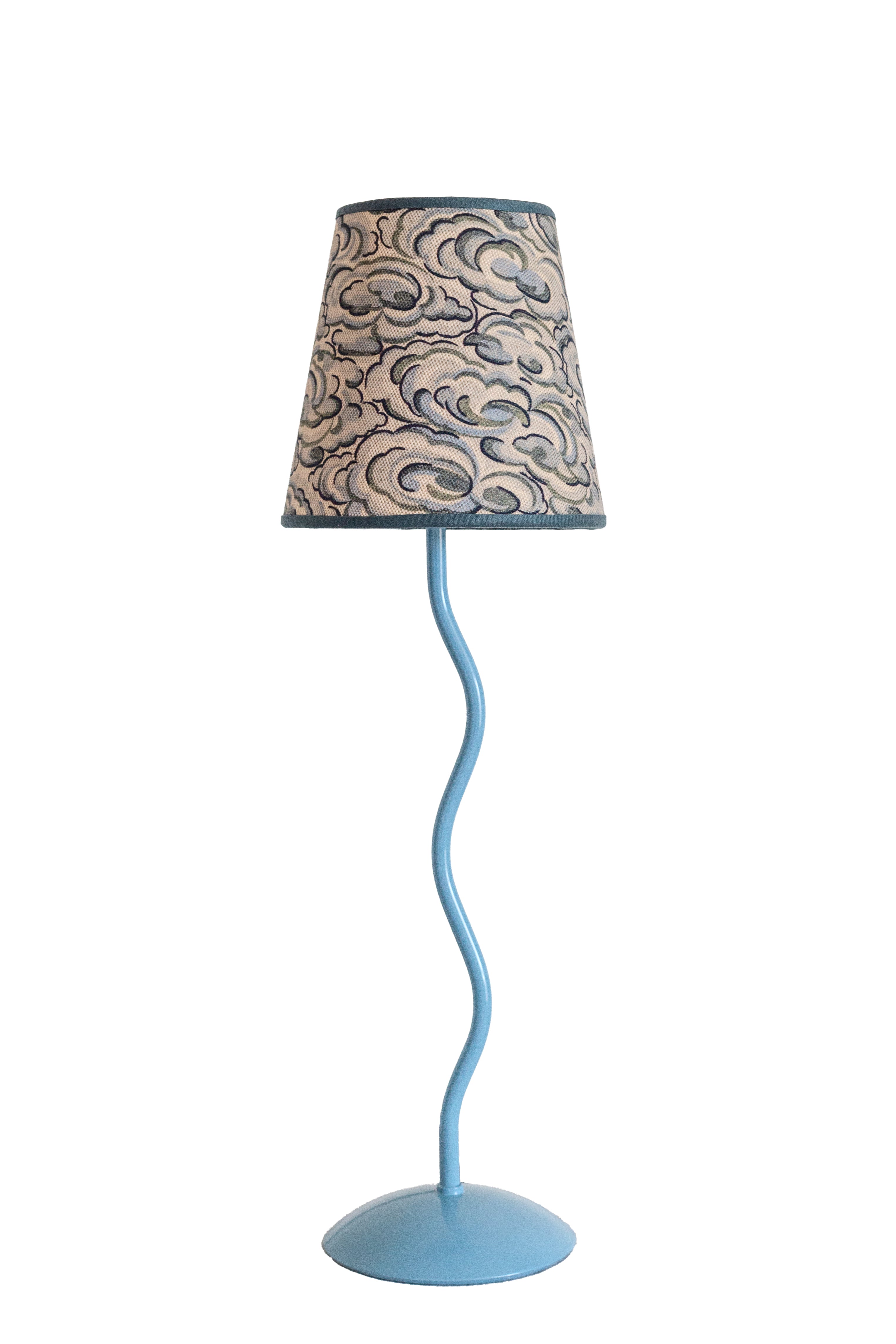 A light blue wavy metal floor lamp with a beige and gray kumo clouds lampshade featuring an intricate cloud pattern