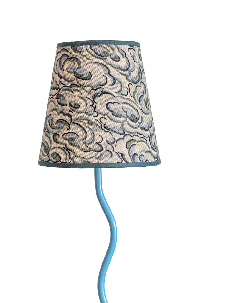 A slender light blue lamp with a kumo clouds lampshade in gray and cream textured fabric