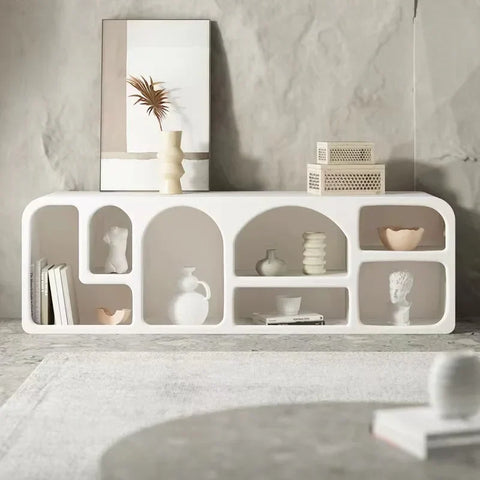 White modern modular kure cabinet with arched and rectangular shelves displaying vases and books