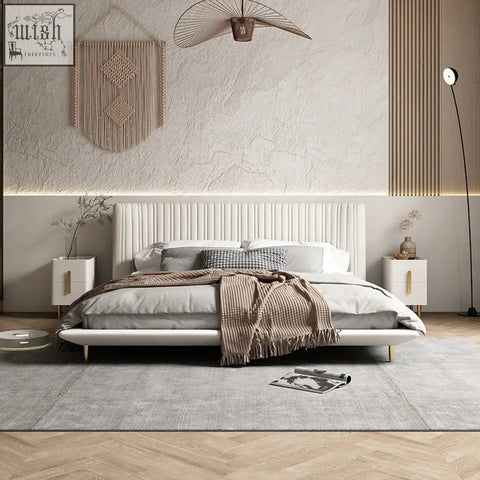 Modern kuri bed with white upholstered tufted headboard and light wood legs offering chic comfort with vertical channelling