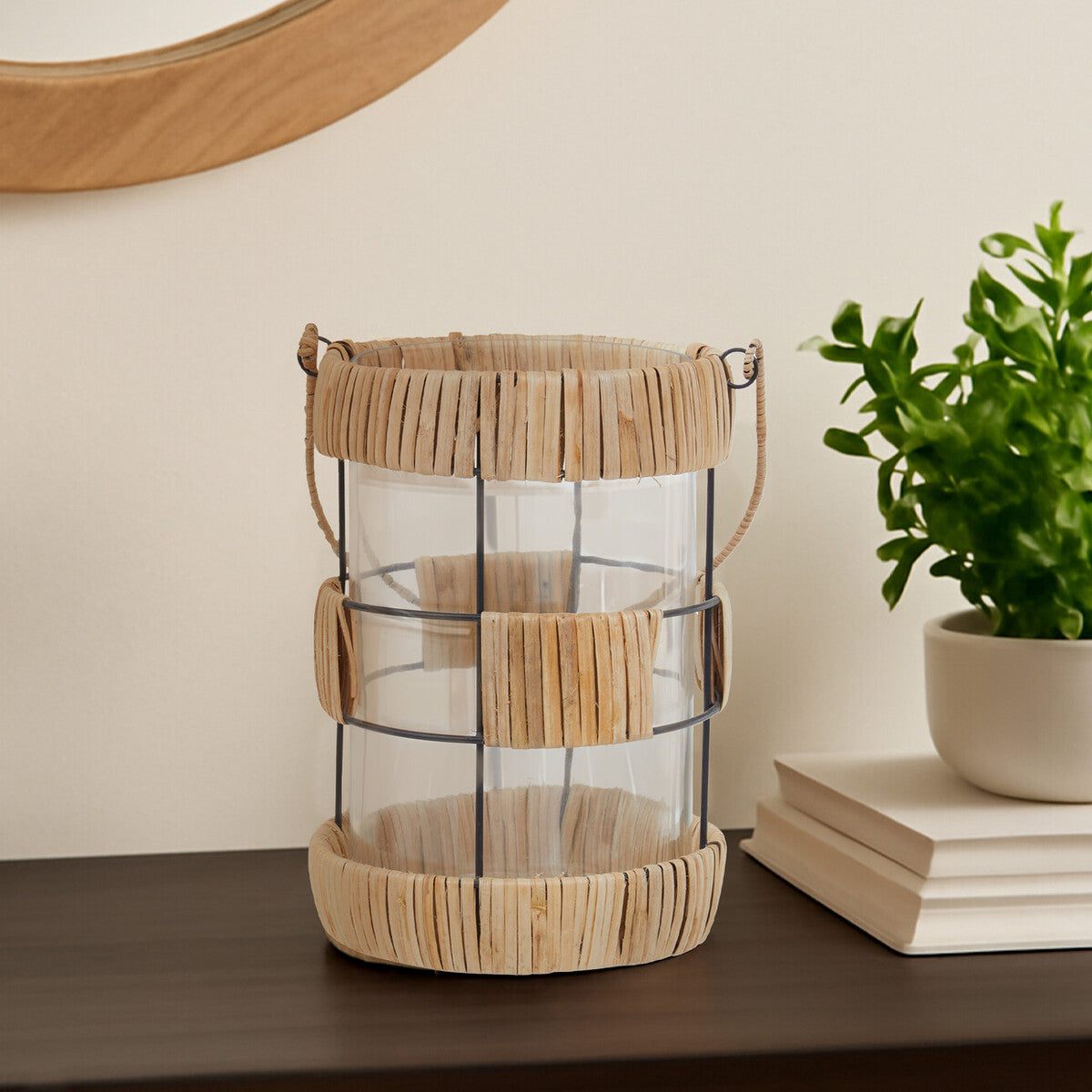 Kuta natural and black large lantern featuring a rattan-wrapped glass with black metal frame and handles