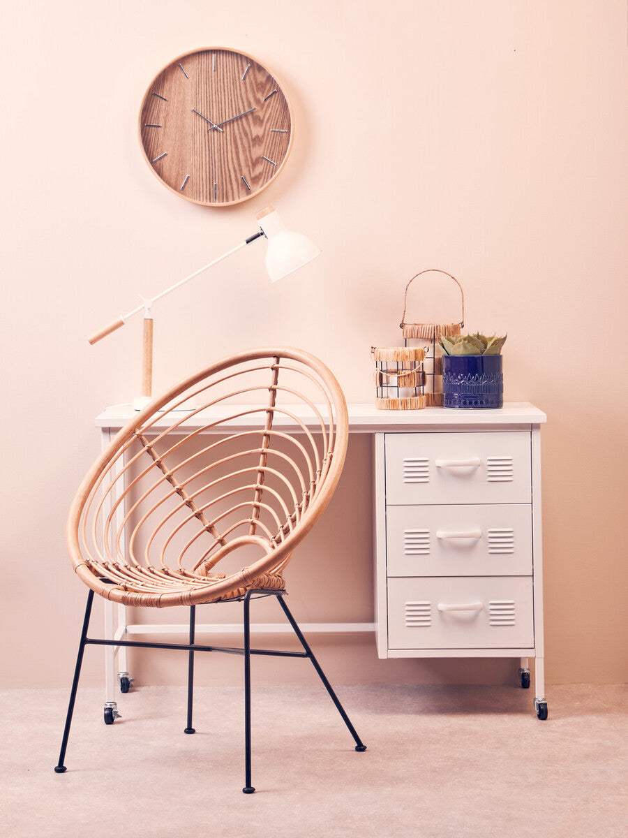 Woven rattan chair with black metal legs paired with kuta natural and black large lantern for stylish decor
