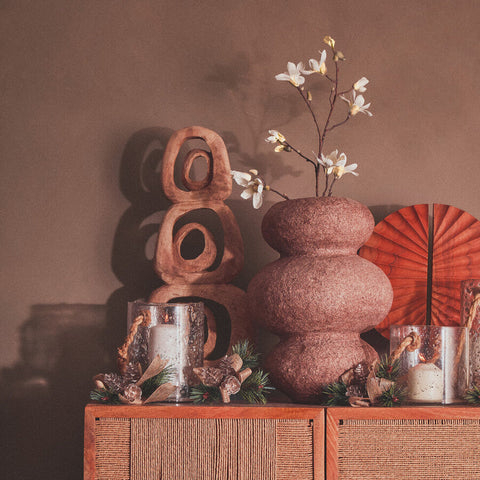 A textured terracotta ceramic vase with rounded segments in the kuta natural rope medium lantern design