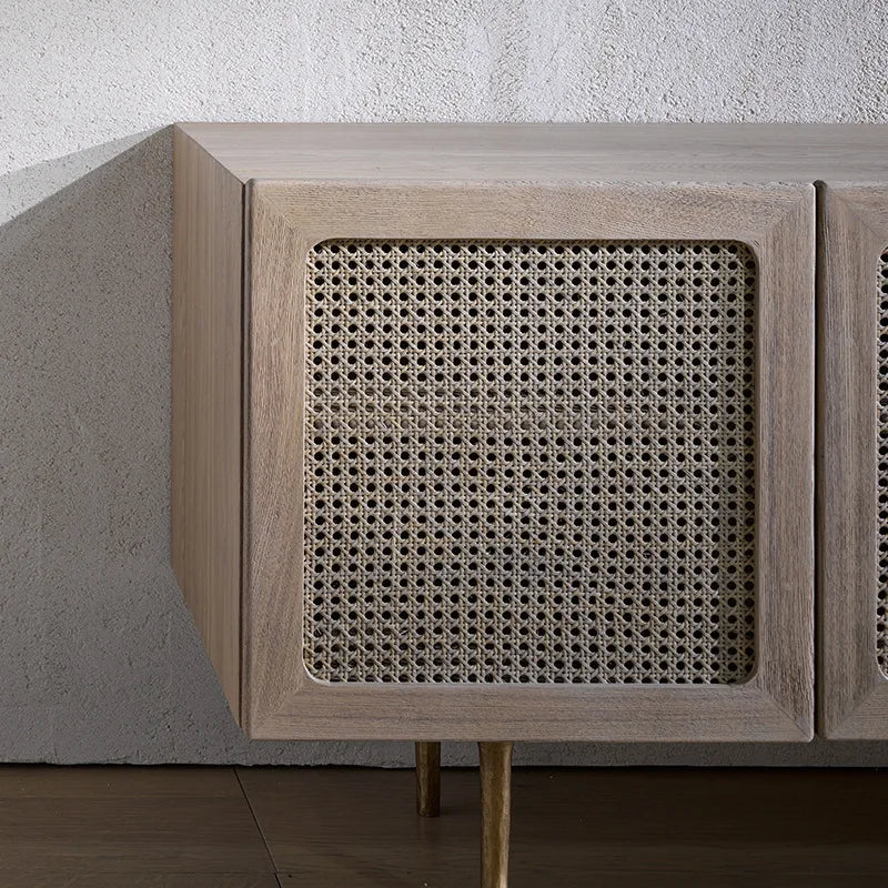 Light gray wood kyoto cabinet with woven cane panel doors and slender gold legs for stylish storage
