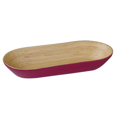 A sleek oblong bowl made of spun bamboo with a raspberry exterior and natural wood interior perfect for serving