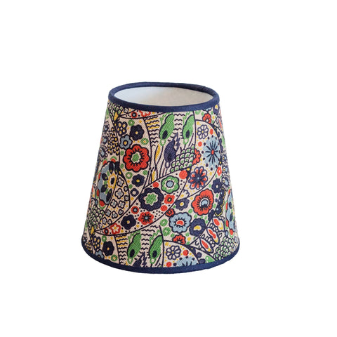 A kyoto woodblock conical lampshade with vibrant floral and bird patterns in reds greens blues and yellows on cream