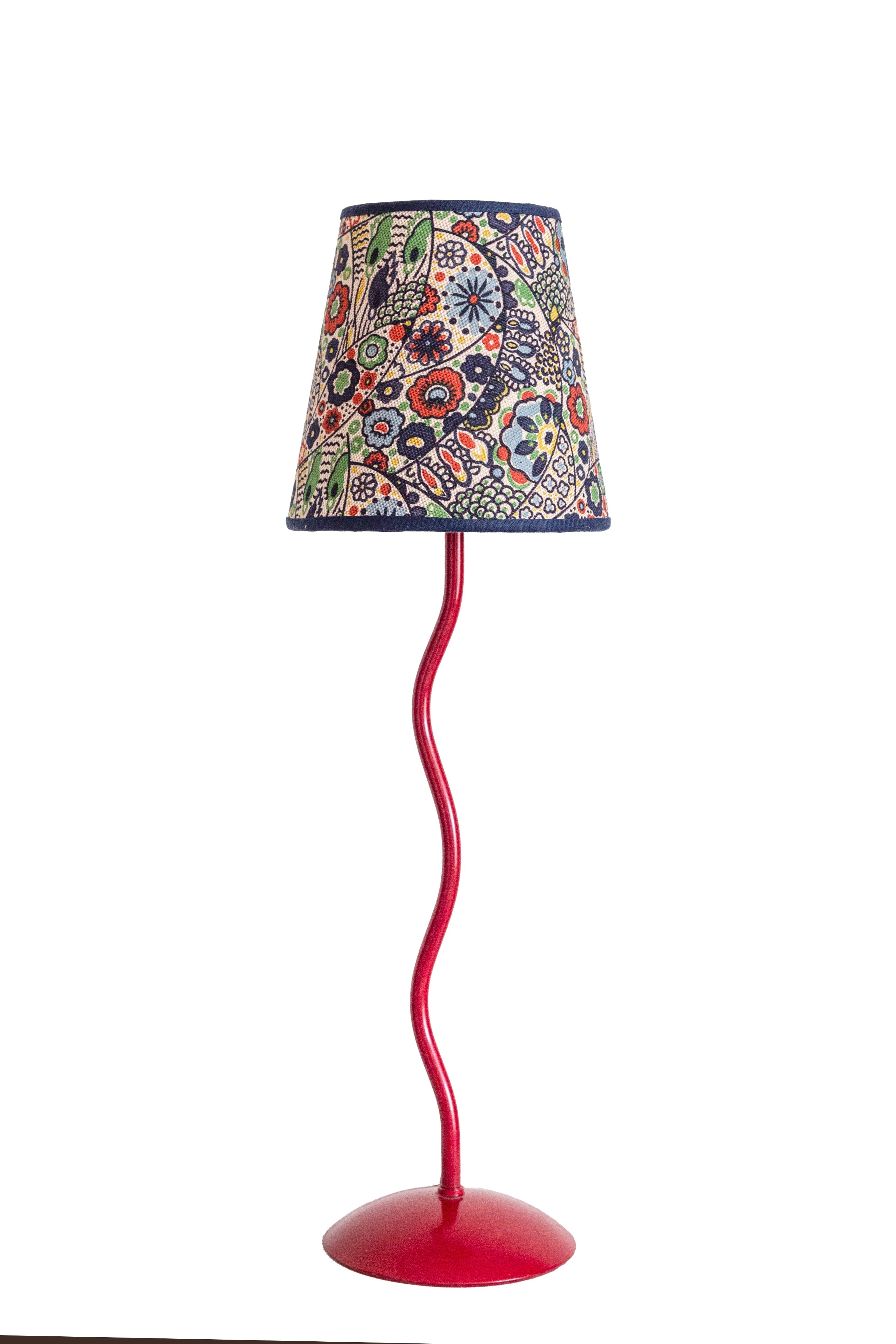 A vibrant red wavy metal floor lamp with a colorful floral kyoto woodblock lampshade perfect for cozy spaces