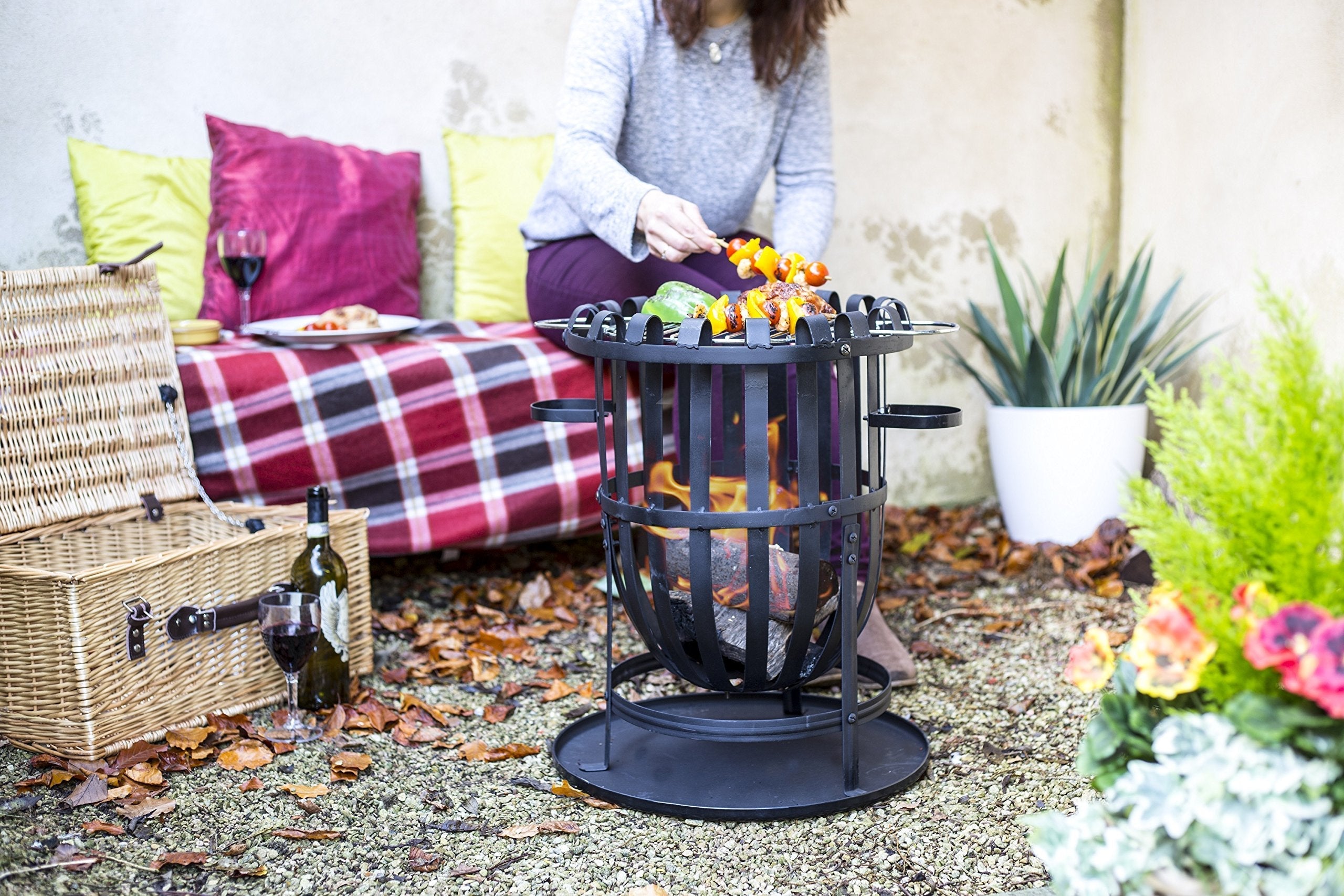 Black wrought iron vancouver firebasket with circular grill and side handles perfect for outdoor gatherings