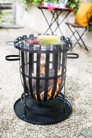 La hacienda vancouver black firebasket is a black wrought iron outdoor fire pit with grill top perfect for outdoor gatherings
