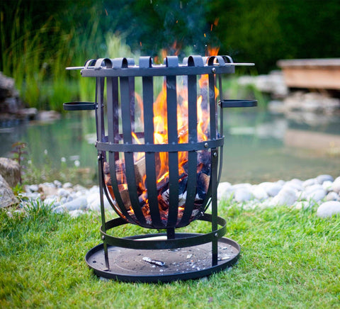 Black wrought iron outdoor fire pit with vertical bars and side handles called hacienda vancouver black firebasket ideal for gatherings