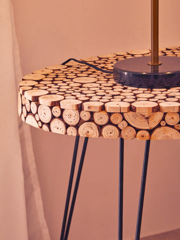 Lacuna fir wood oval coffee table with natural wood slice top in warm beige and black metal hairpin legs