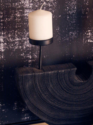 Lacuna two candle holder with white cylindrical candle in black metal two candle holder on dark wooden base