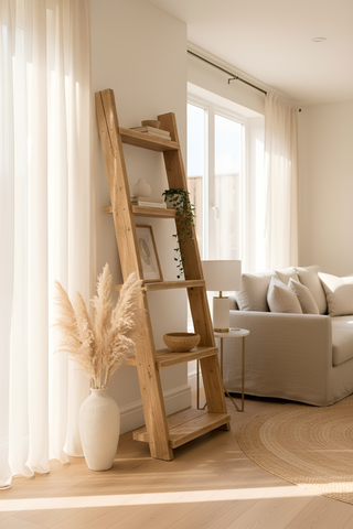 A rustic ladder solid wood bookshelf with a natural finish featuring slanted shelves for decor and greenery