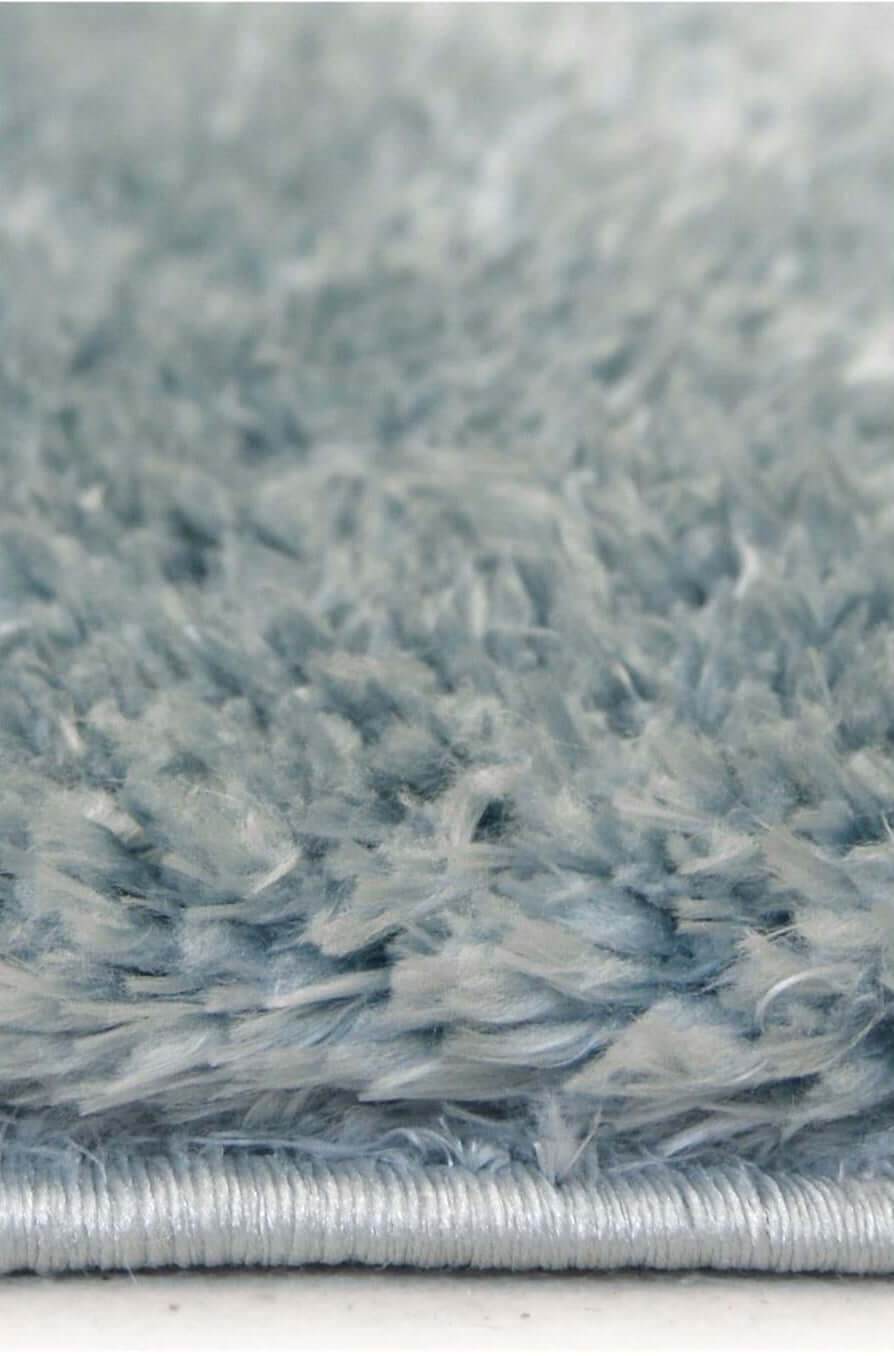 A plush lagom duck egg blue shaggy rug with soft textured surface and neatly finished silver-colored edge