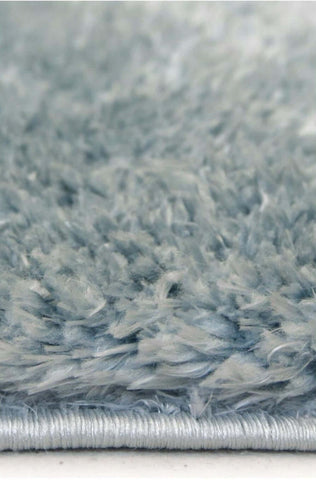 A plush lagom duck egg blue shaggy rug with soft textured surface and neatly finished silver-colored edge