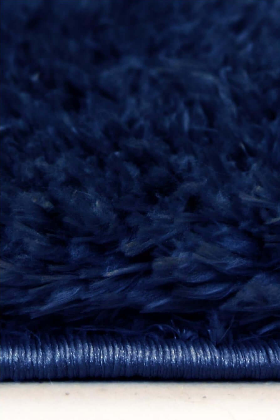 Lagom navy shaggy rug with deep navy blue plush shag texture and tightly woven edge for cozy spaces